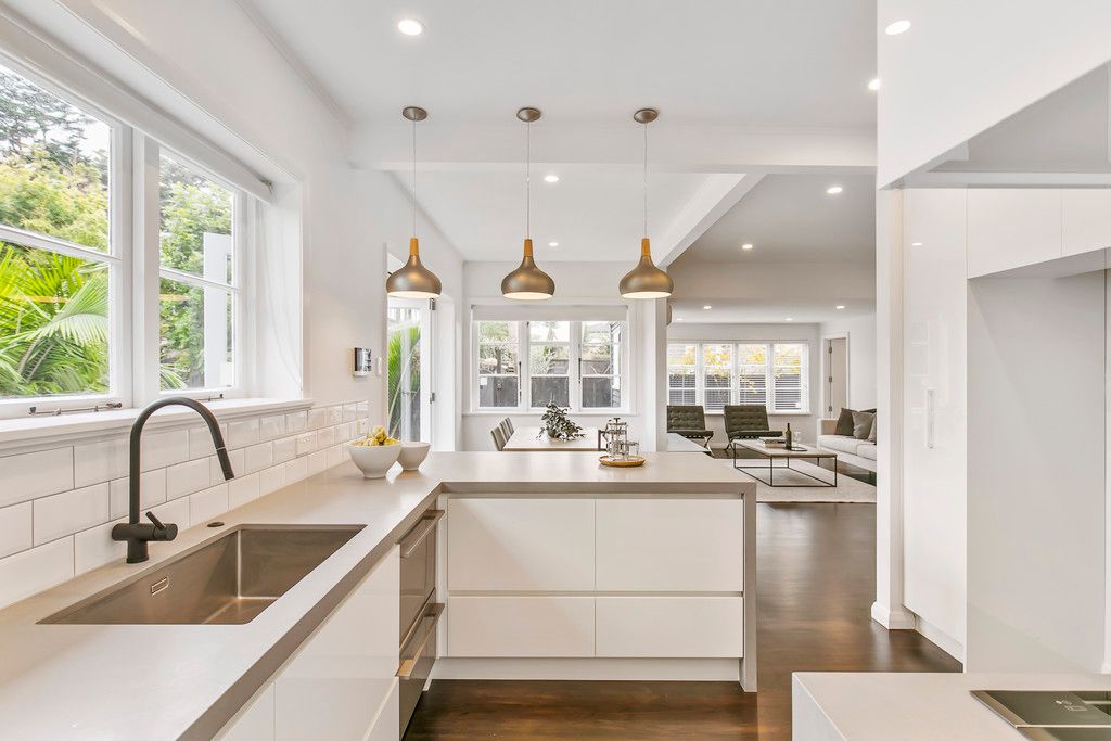 Kitchen with brass pendant trio and under cabinet lighting