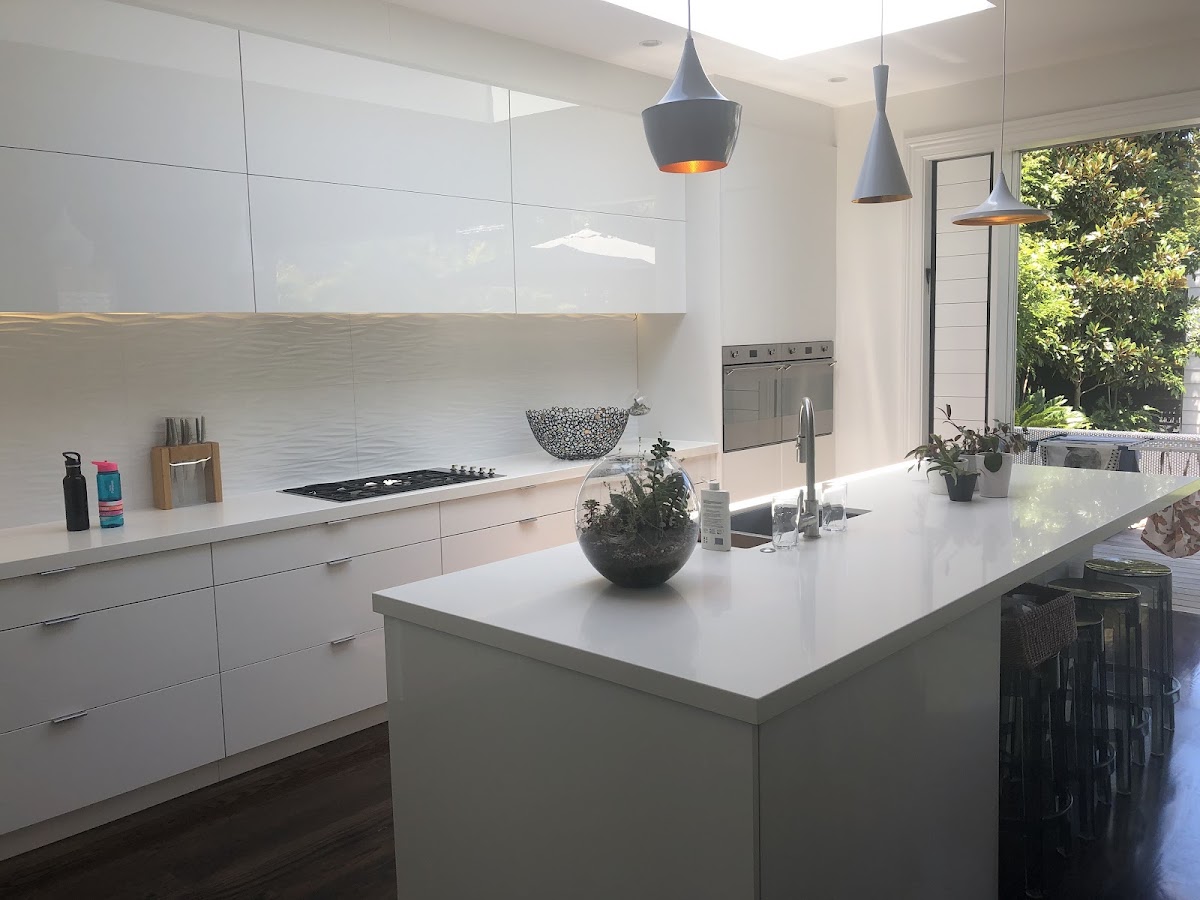 White kitchen with sculptural pendant lighting installed by Just Wright Electrical