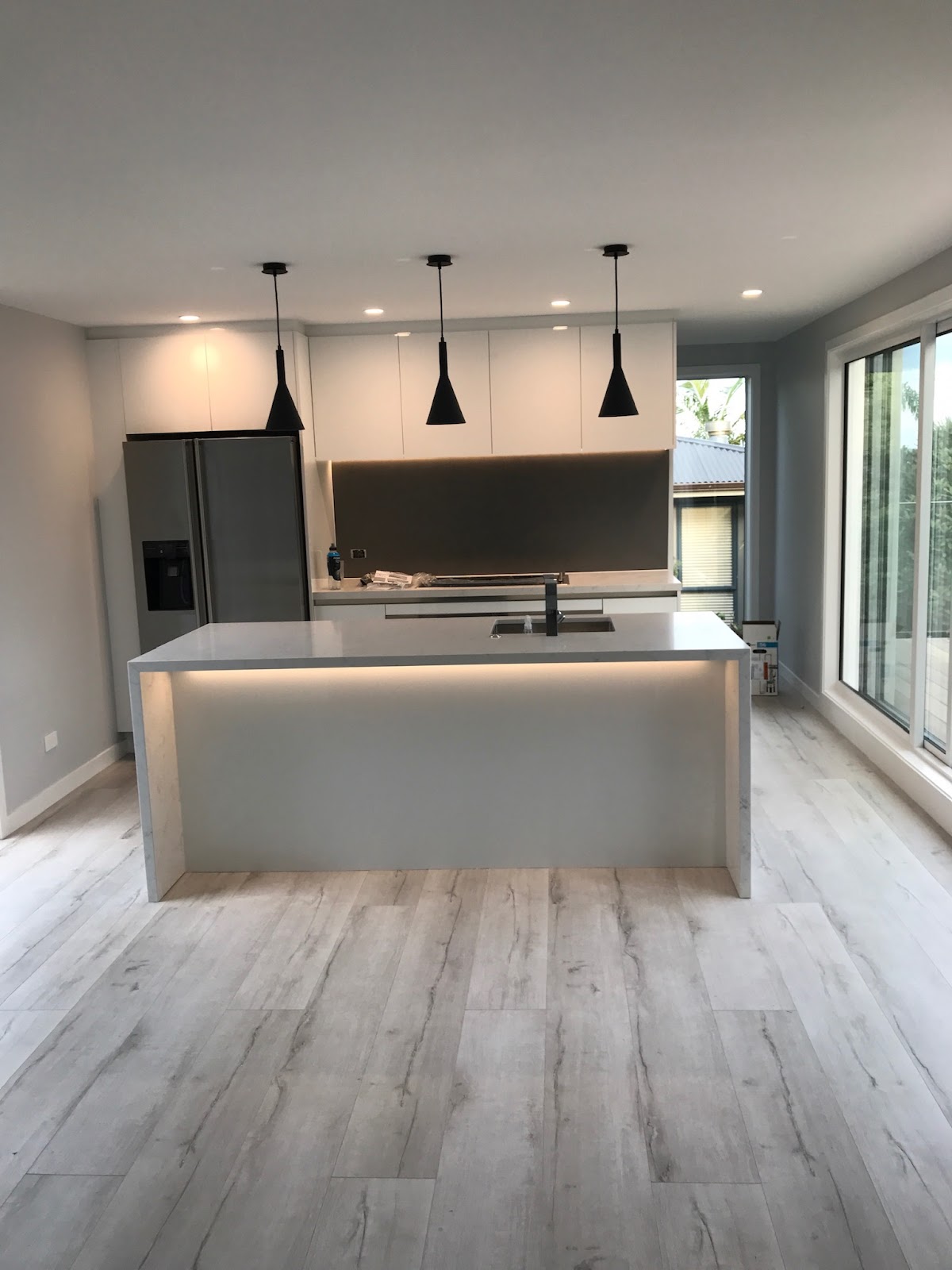 New build kitchen with pendant lighting and under bench strip lighting